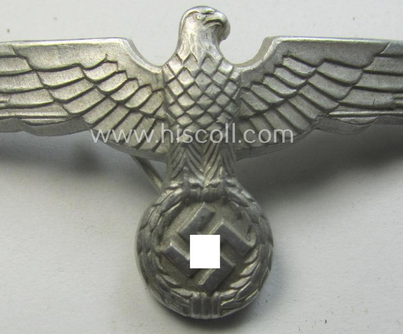 WH (Heeres) bright-silver-toned (ie. typical aluminium-based), EM- (ie. NCO- or officers') type visor-cap-eagle being a maker- (ie. 'R.H.'-) marked and/or: '1938'-dated example that comes in a moderately used- ie. once cap-attached-, condition