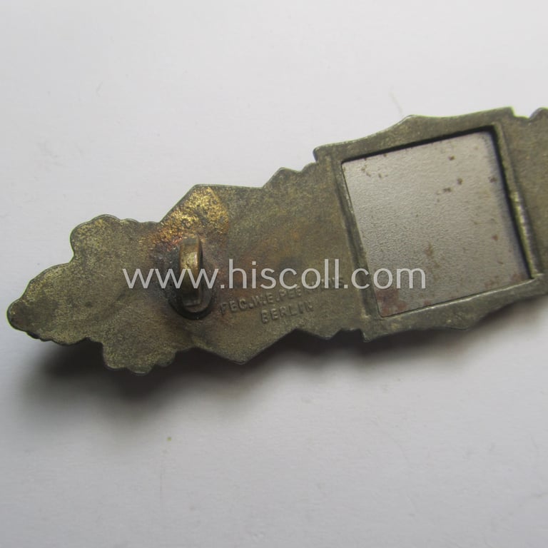 'Nahkampfspange in Bronze' (or: bronze-class close-combat clasp ie. CCC) being a (typical) maker-marked- and/or minimally converse-shaped specimen as was produced by the maker- (ie. 'Hersteller') 'Friedrich Linden' (ie. FLL)