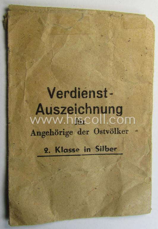 Superb, WH-related: 'Verdienstsauszeichnung für Angehörige der Ostvölker, 2. Kl. in Silber ohne Schwertern' being a maker- (ie. '100'-) marked example that comes stored in its period 'Zellstoff'-based pouch