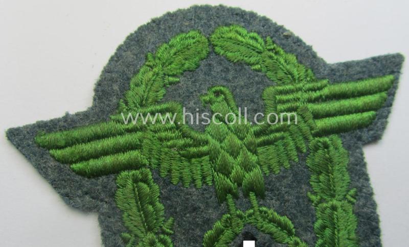 Clearly used- and/or tunic-removed, police- (ie. 'Polizei'- ie. 'Gendarmerie'-) related machine-embroidered-pattern arm-eagle, as executed in bright-green-coloured linnen on a typical 'Polizei'-coloured- and/or woolen-based, background