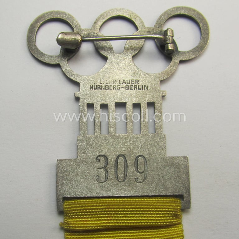 Stunning - and actually never before seen! - 'Richter-Abzeichen' being a maker- (ie. 'L.Chr. Laurer'-) marked example that is showing the Olympic-rings above an illustration of the: 'Reichstag' coupled with a yellow ribbon showing the text: 'Ringen'