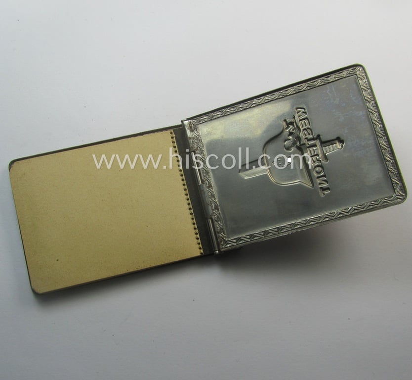 Interesting, WWII-period 'souvenir-item' (ie. tiny note-book) showing on its front an illustration of a steel-helmet and upright-positioned sword coupled with the text: 'Westfront'