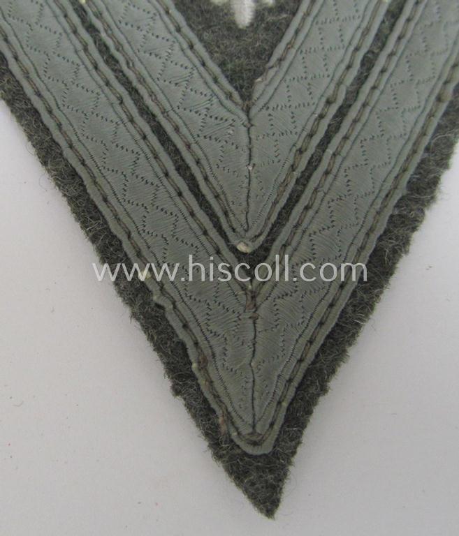 WH (Heeres) 'Armwinkel' (or: arm-chevron) as executed on typical field-grey-coloured wool as was specifically intended for usage by a soldier with the (unusually seen!) rank of: 'Stabsgefreiter'