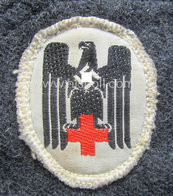 Darker-greyish-blue-coloured, so-called: German Red Cross (ie. 'Deutsches Rotes Kreuz' or: 'DRK' EM- (ie. NCO-) type side-cap (ie. 'Schiffchenmütze für Mannschaften u. Uffz. des deutschen Rotes Kreuzes')