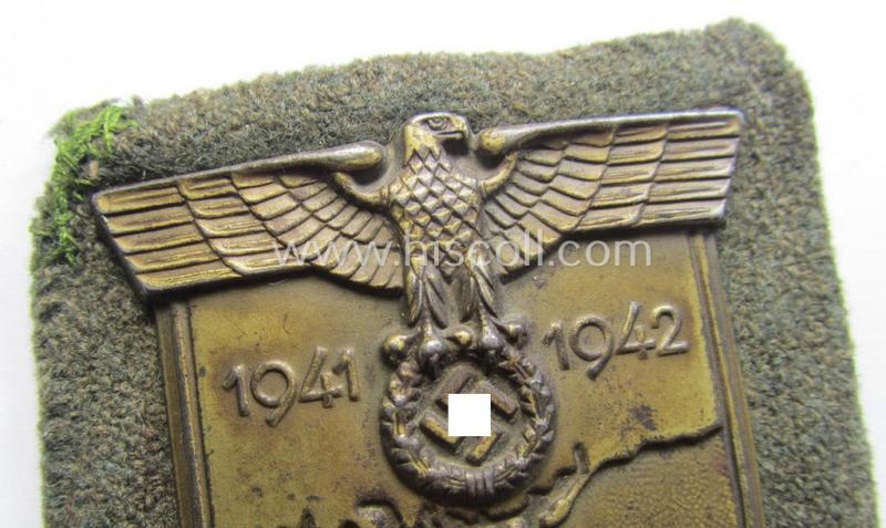 Attractive - truly worn! - WH (Heeres o. Waffen-SS) 'Krim'-campaign-shield that comes mounted onto its original, field-grey-coloured 'backing' and that comes in a surely issued-, worn and/or carefully tunic-removed-, condition