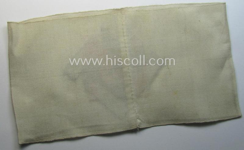 Attractive, beige-white-coloured and typical linnen-based so-called: TeNo (ie.: 'Technische Nothilfe') 'Amtsträger'-armband depicting the typical 'TeNo'-logo (with TN-lettering) and that comes in a just minimally used- ie. worn, condition