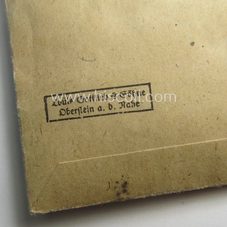 'Ehrenkreuz der deutschen Mutter - dritte Stufe' (or: bronze-class mothers'-cross) that came mounted onto its long-sized ribbon and that came stored in its period pouch by the maker: 'Louis Gottlieb - Oberstein a.d. Nahe'