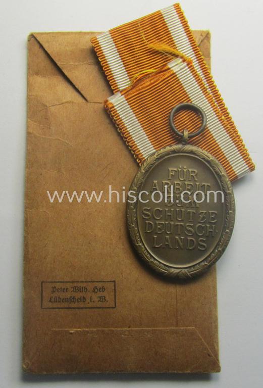 Medal-set: 'Deutsches Schutzwall Ehrenzeichen' (aka: 'Westwall'-medal) being a (typical) non-maker-marked- and/or: typical 'Buntmetall'-based specimen that comes packed in its original pouch of issue by the: 'Peter Wilh. Heb'-company