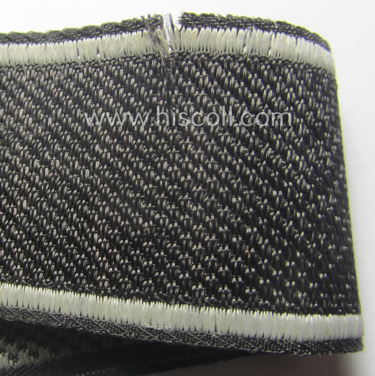 Waffen-SS, 1943/44 pattern cuff-title (ie. 'Ärmelstreifen') depicting the machine-woven Latin script text in silver-grey linnen as was intended for a member of the: 'SS-Regiment': "Westland" (ie. part of the: '5. SS-Pz-Gren.-Div. "Wiking")