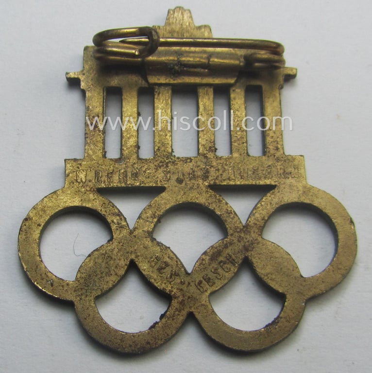 Commemorative - and neatly enamelled! - 'Veranstaltungsabzeichen' being a maker- (ie. 'W. Redo'-) marked example that is showing the Olympic-rings above an illustration of the: 'Reichstag' coupled with the text: 'XI. Olympiade Berlin 1936'