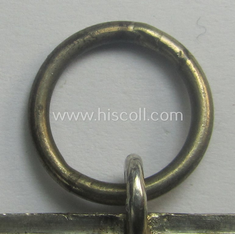 Matching 'EK II. Klasse'-set comprising of a non-maker-marked specimen that comes with its ribbon (ie. 'Bandabschnitt') and 'Zellstoff'-based pouch as was produced by the company: 'L.Chr. Lauer' (ie. 'Hersteller 14')