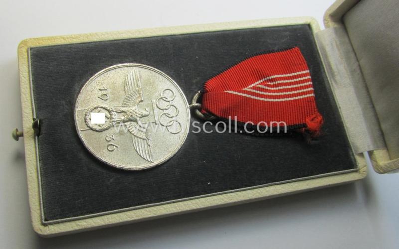 Superb, 'Deutsche Olympia-Erinnerungsmedaille 1936' being a non-maker-marked example that comes mounted onto its original ribbon (ie. 'Bandabschnitt') and that comes stored in its typical, beige-white-coloured etui as issued and stored for decade...