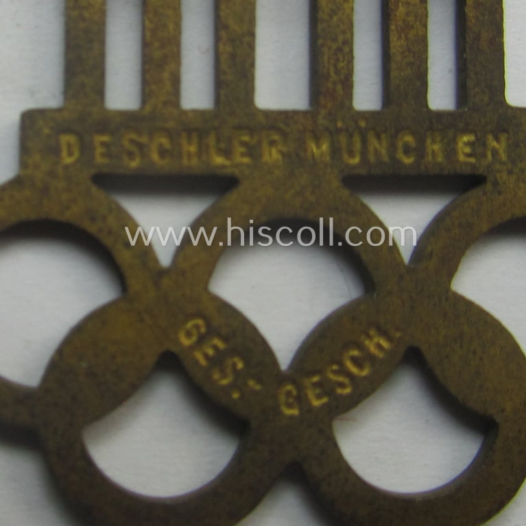 Commemorative - and neatly enamelled! - 'Veranstaltungsabzeichen' being a maker- (ie. 'Deschler'-) marked example that is showing the Olympic-rings above an illustration of the: 'Reichstag' coupled with the text: 'XI. Olympiade Berlin 1936'