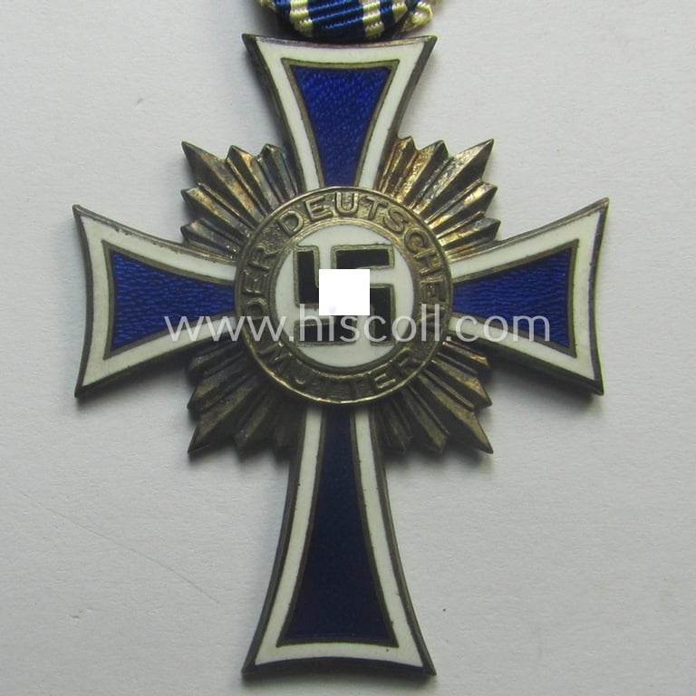 'Ehrenkreuz der deutschen Mutter - zweite Stufe' (or: silver-class mothers'-cross) that came mounted onto its long-sized ribbon and that came stored in its period pouch by the maker: 'Moriz Hausch A.-G. - Pforzheim'