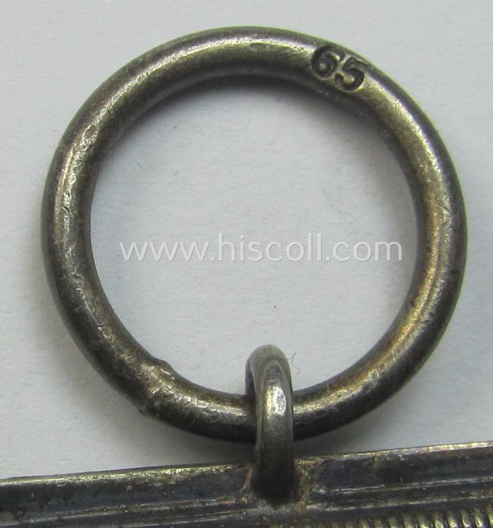 Attractive, 'Eisernes Kreuz II. Klasse' being a maker- (ie. '65'-) marked example that comes together with its original- and once-mounted ribbon (ie. 'Bandabschnitt') as was produced by the maker (ie. 'Hersteller'): 'Klein & Quenzer'