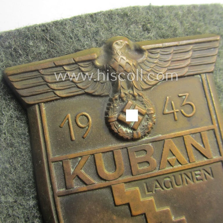 Truly worn, WH (Heeres ie. Waffen-SS) 'Kuban'-campaign-shield that comes mounted onto its original field-grey-coloured- and/or woolen-based 'backing' as issued and/or used