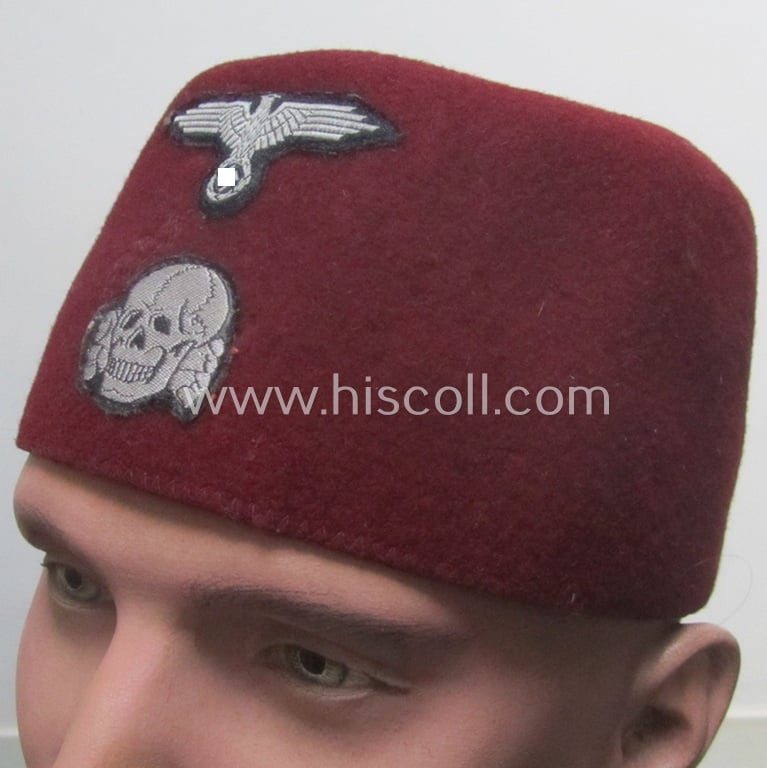 Superb, maroon-red-coloured, Waffen-SS-pattern so-called: 'Fez' having a neat - and fully matching! - silver-grey-coloured- and/or 'BeVo'-woven insignia-set originally- (ie. 'off-factory'-) attached