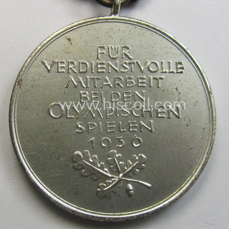 'Deutsche Olympia-Erinnerungsmedaille 1936' being a non-maker-marked example that comes mounted onto its original ribbon (ie. 'Bandabschnitt') and that comes stored in its typical, beige-white-coloured etui
