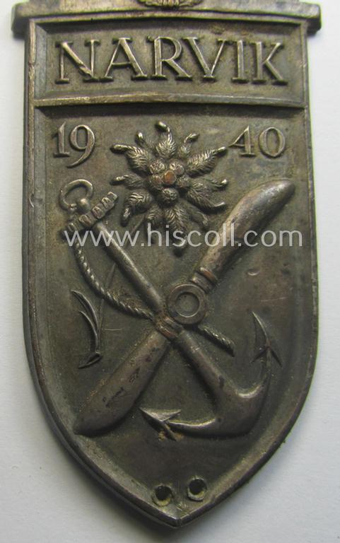 Truly worn - but regrettably incomplete but nevertheless rarely encountered! - WH (Heeres) 'Narvik'-campaign-shield as executed in silver-toned 'Buntmetall' (ie. Cupal) and that comes in a clearly issued- (and once tunic-attached-), condition