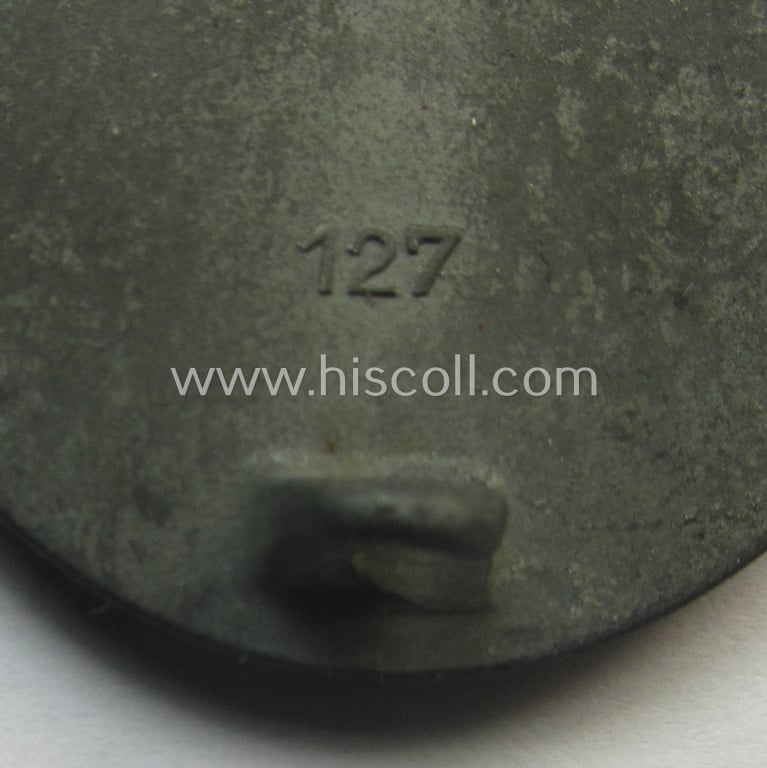 Unusual, silver-class wound-badge (or: 'Verwundeten-Abzeichen in Siber') being a maker- (ie. '127'-) marked example that comes stored in its original (damaged), carton-based pouch by the maker (ie. 'Hersteller'): 'Moriz Hausch A.-G.'