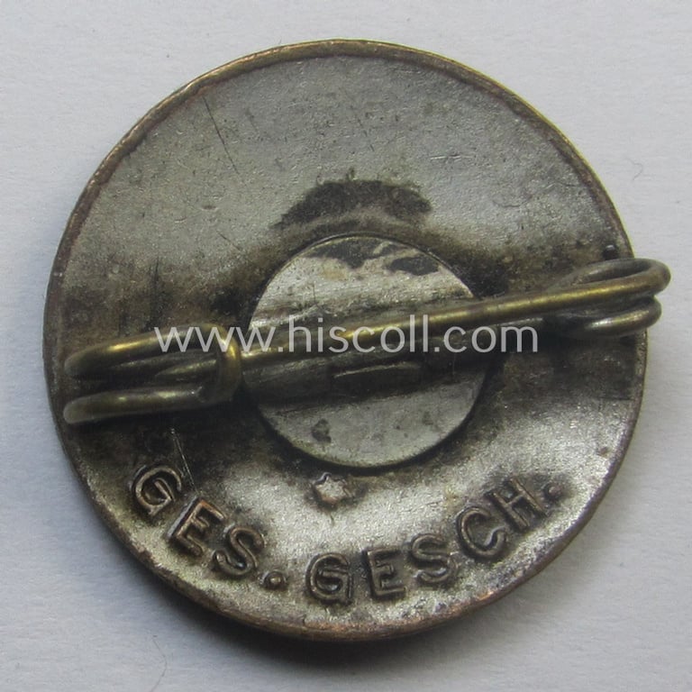 Unusual, early-period - smaller-sized- and darker-red-coloured! - 'N.S.D.A.P.'-membership-pin- ie. party-badge (or: 'Parteiabzeichen') being a non-maker-marked example that shows a 'Ges.Gesch.'-patent-pending-designation