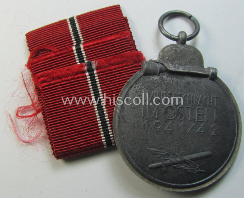 Attractive medal-set: 'Winterschlacht im Osten 1941-42' being a maker- (ie. '6.'-) marked- (and/or 'Feinzink'-based) specimen by the maker: 'Fritz Zimmermann' and that comes together with its (non-confectioned) ribbon (ie. 'Bandabschnitt')