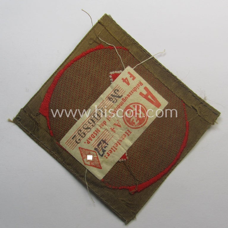 Moderately used, DJ (ie. 'Deutsches Jungvolk') arm-badge as was specifically intended for usage by a member who served within the: 'Oberbann 1' (being a tunic-removed example that still shows its 'RzM'-etiket)