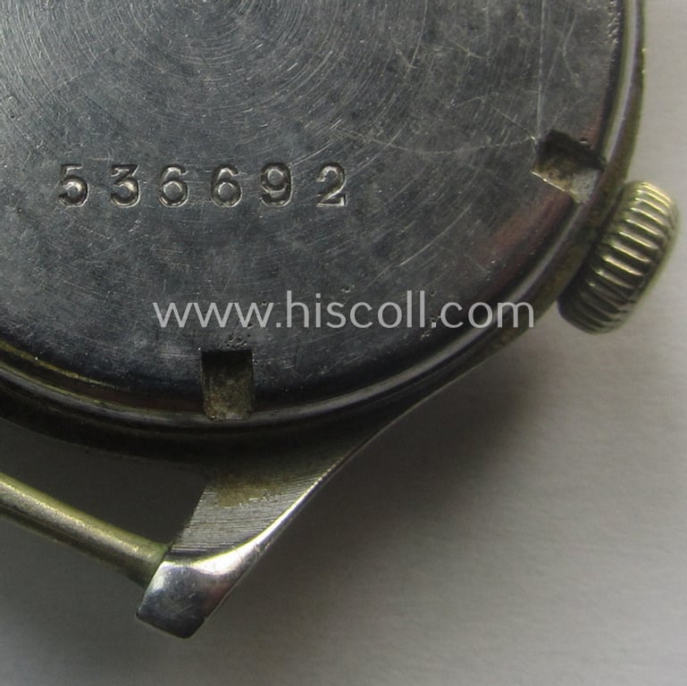 WH (Kriegsmarine) WWII-period wrist-watch (or: 'Dienstuhr') of the make: 'K.M. Zentra' having a beige-yellow-coloured dial-plate and neatly engraved number on its back that reads: '536692'