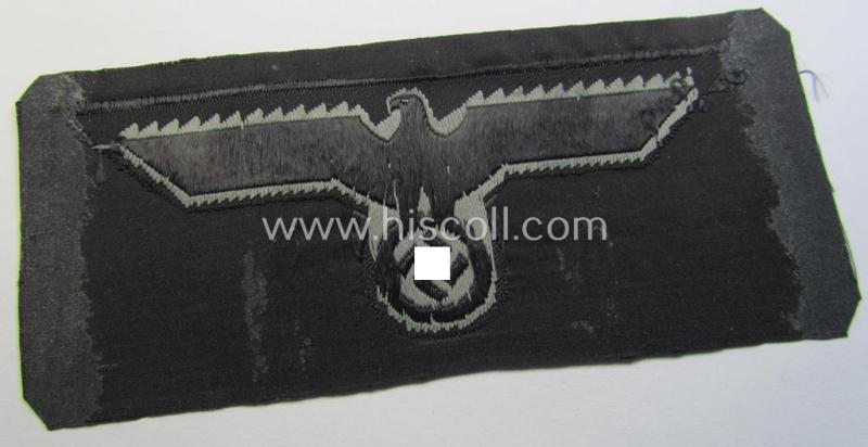 Later- (ie. mid-war-) period, WH (Heeres) 'Panzer'-type breast-eagle (ie. 'Brustadler für Panzertruppen') being a 'virtually mint- ie. unissued' example as executed in bluish-grey-coloured linnen on a black-coloured background