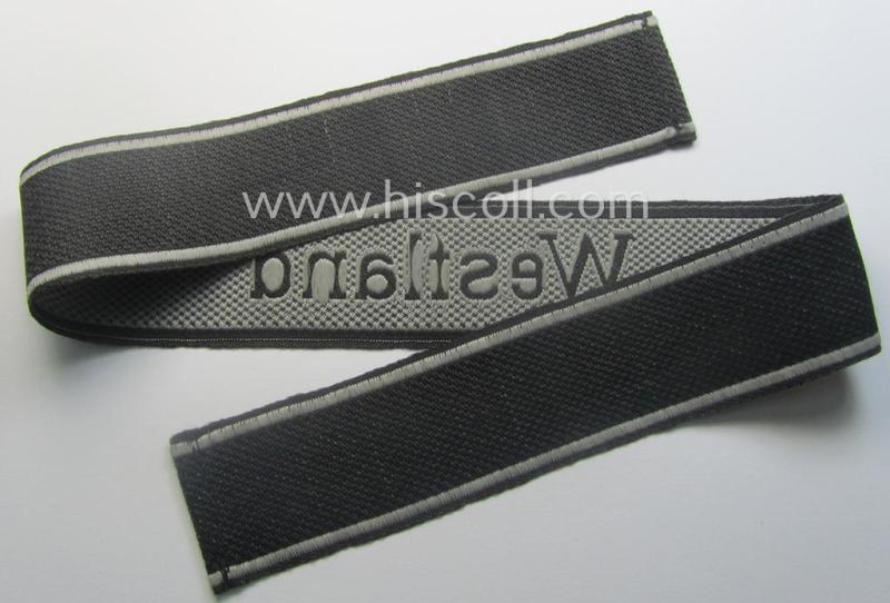 Waffen-SS, 1943/44 pattern cuff-title (ie. 'Ärmelstreifen') depicting the machine-woven Latin script text in silver-grey linnen as was intended for a member of the: 'SS-Regiment': "Westland" (ie. part of the: '5. SS-Pz-Gren.-Div. "Wiking")