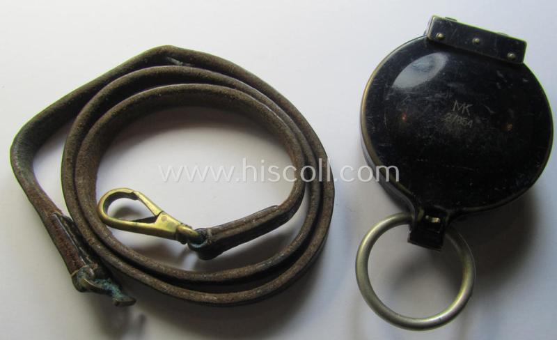 Superb, 'standard-issue'-pattern, black-coloured and/or copper-based WH-compass (ie. 'Marschkompass') which is nicely 'MK'-marked and/or individually numbered: '27854' and that comes mounted onto its period 'Fangschnur'