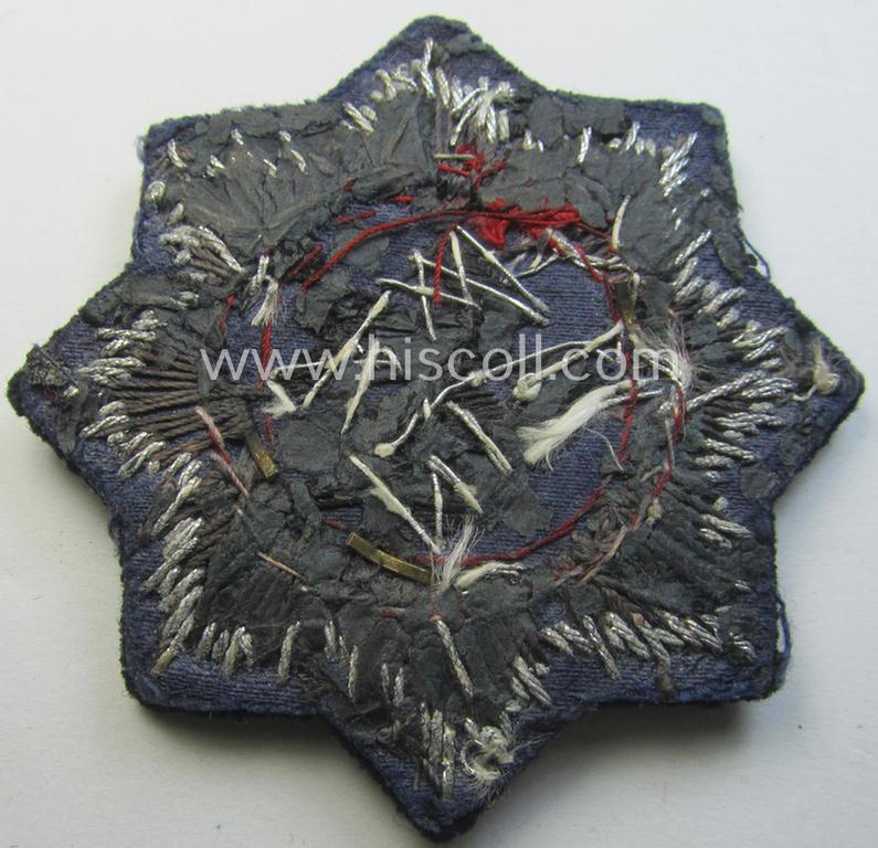 Black-toned, WH (Heeres o. Waffen-SS 'Panzer' ie. Kriegsmarine-related-) 'Deutsches Kreuz im Gold in Stoff' (ie. cloth-based DKiG or German Cross in gold)