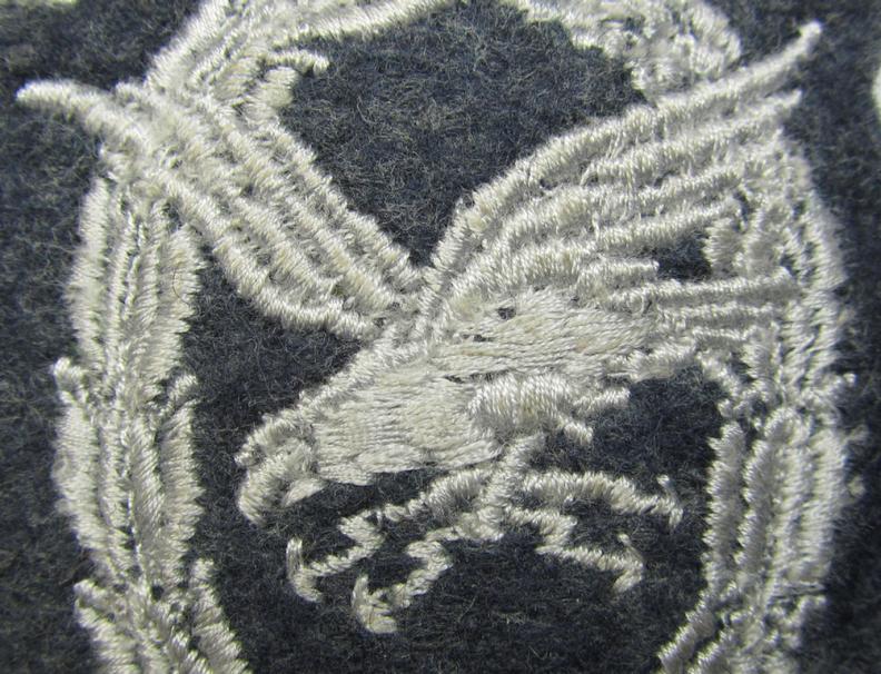 Superb example of a WH (Luftwaffe) so-called: 'Fliegerschützen-Abzeichen mit Blitzbündel in Stoff' (or: cloth air-gunners-badge with lightning bolts) being a machine-stitched- and/or nicely 'padded' specimen that still shows its inventory-etiket