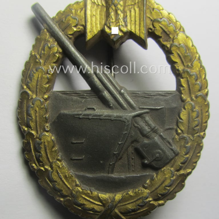 WH (KM) 'Marine-Artillerie-Abzeichen' being a maker- (ie. 'F.L.L. - 43'-) marked- and/or zinc- (ie. 'Feinzink'-) based example by the: 'Friedrich Linden'-company