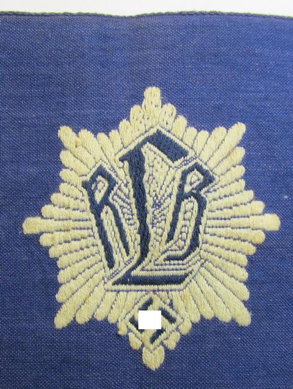 Attractive, darker-blue-coloured so-called: RLB (or: 'Reichsluftschutzbund') 'Amtsträger'-armband depicting the typical 'RLB'-logo (with lettering) and showing an interwoven 'Ges.Gesch.'-patent-pending-designation