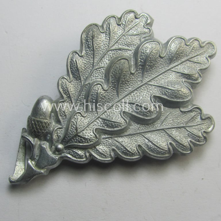 WH (Heeres) silver-coloured so-called: 'M43'-pattern cap-badge (ie. 'Mützenabzeichen') depicting three: 'Eichenlaub'-branches as was used by the various 'Jäger'-related, divisional staff-members