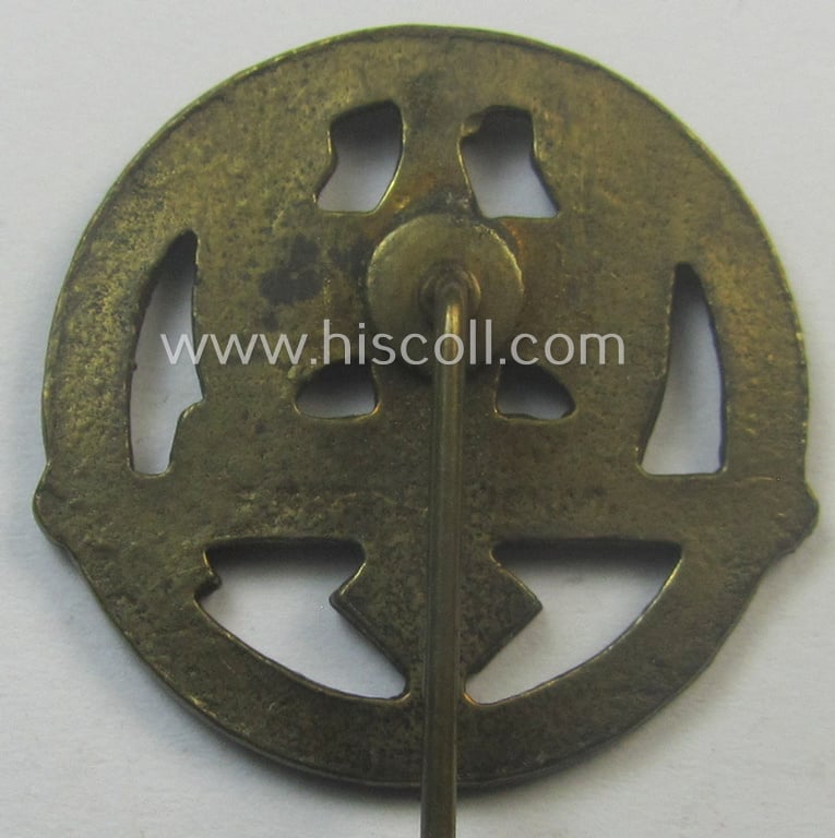 Golden-bronze-toned, so-called: 'Nationalsozialistischer Soldatenring' (ie. 'NSR') membership-badge (or: 'Mitgliedsabzeichen') being a maker- (ie. 'F. Petzl'-) marked example that comes mounted onto its long-sized pin