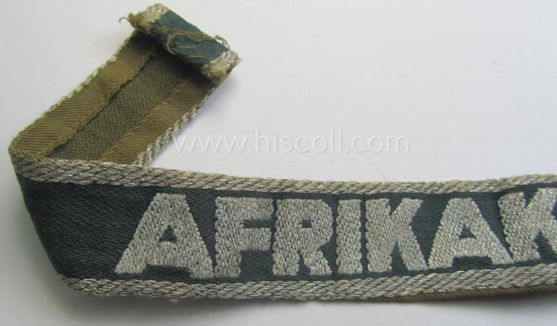 Truly worn, 'BeVo'-like cuff-title (ie. 'Ärmelstreifen') entitled: 'Afrikakorps' being a with certainty issued example that comes in an overall nice- (ie. somewhat shortened- and/or once tunic-attached-), condition