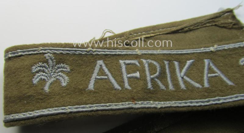 WH (LW o. Heeres) cuff-title (ie. 'Ärmelstreifen') entitled: 'Afrika' (being an example that comes in a presumably issued- albeit simply never used- ie. 'virtually mint' condition)