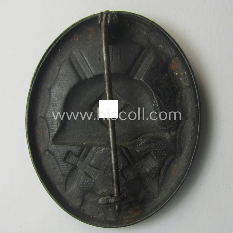 Dual-maker- (ie. 'E.H.'- and/or: '126'-) marked example of a black-class wound-badge (or: 'Verwundeten-Abzeichen in Schwarz') being an example that was produced by the maker (ie. 'Hersteller') named: 'Eduard Hahn'