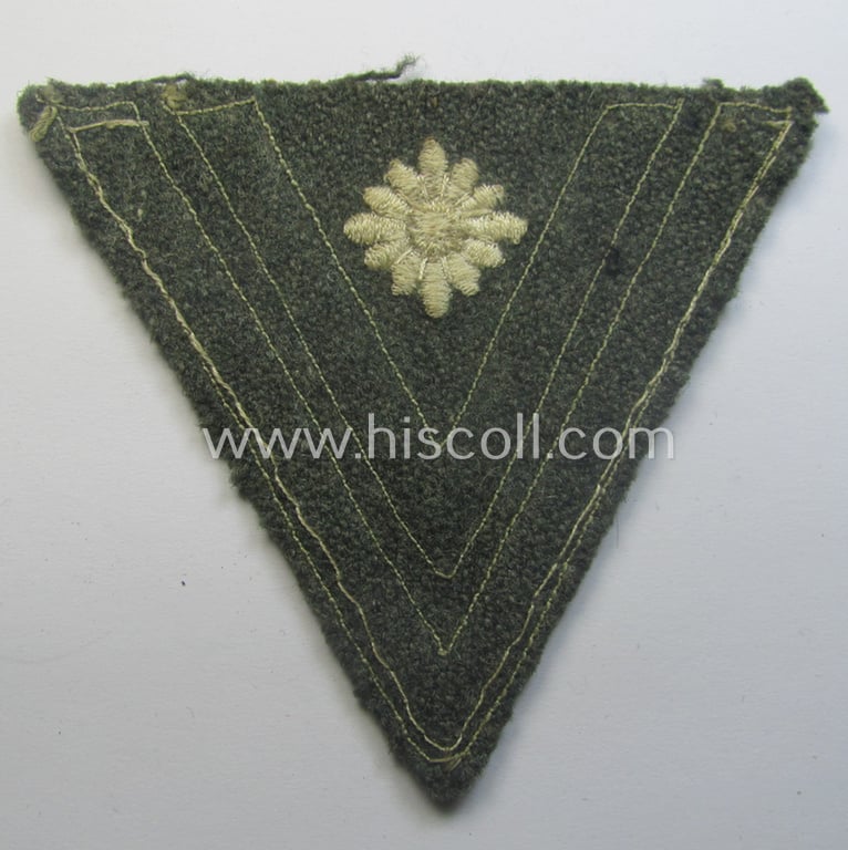 WH (Heeres) 'Armwinkel' (or: arm-chevron) as executed on typical field-grey-coloured wool as was specifically intended for usage by a soldier with the (unusually encountered!) rank of: 'Stabsgefreiter'