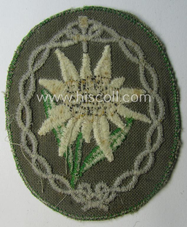 'Variant'-pattern WH (Heeres) 'Gebirgsjäger'- (ie. mountain-troopers-) related arm-badge, being a desirable example as was executed in the machine-woven pattern on thin-shaped (and bright-green rimmed) background