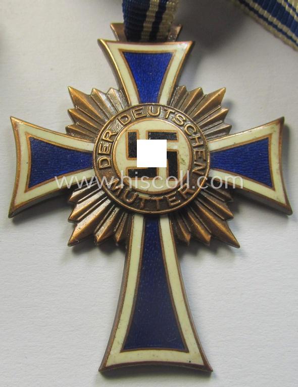 Neat, 'Ehrenkreuz der deutschen Mutter - dritte Stufe' being a non-maker-marked example that comes mounted onto its (large-sized!) ribbon and that comes in an overall very nice- (albeit minimally worn- ie. used-), condition