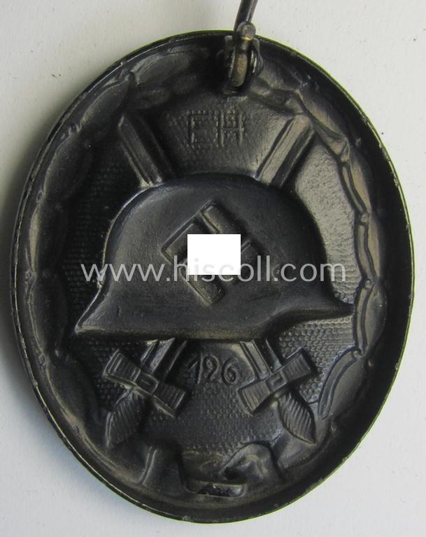 Neat, dual-maker- (ie. 'E.H.'- and/or: '126'-) marked example of a black-class wound-badge (or: 'Verwundeten-Abzeichen in Schwarz') being an example that was produced by the maker (ie. 'Hersteller') named: 'Eduard Hahn'