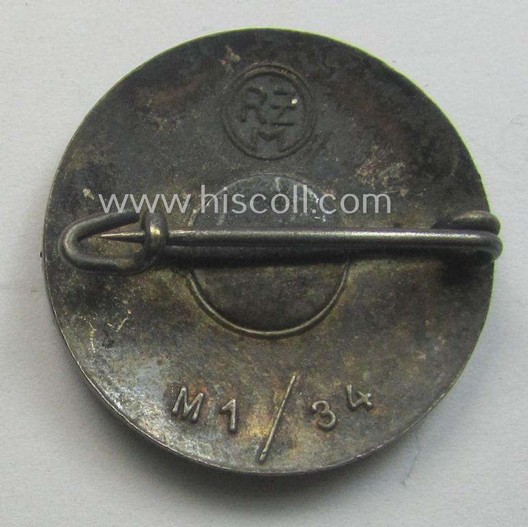 'N.S.D.A.P.'-membership-pin- ie. party-badge (or: 'Parteiabzeichen') which is maker-marked on its back with the makers'-designation: 'RzM' and/or: 'M1/34'