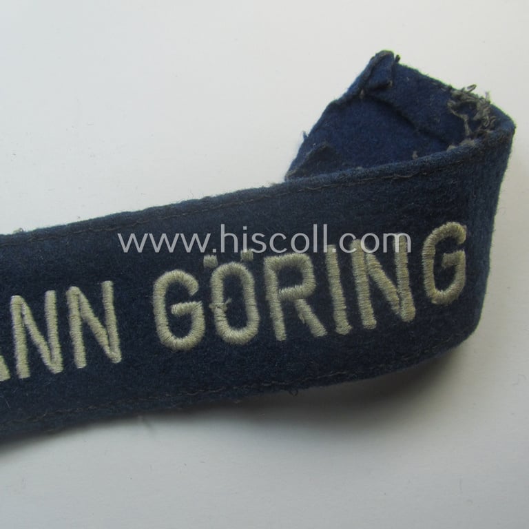 Truly used and typical 'smooth-woolen'-based, EM- (ie. NCO-) pattern WH (Luftwaffe) cuff-title (ie. 'Ärmelstreifen') entitled: 'Hermann Göring' that comes in a period-shortened and worn condition