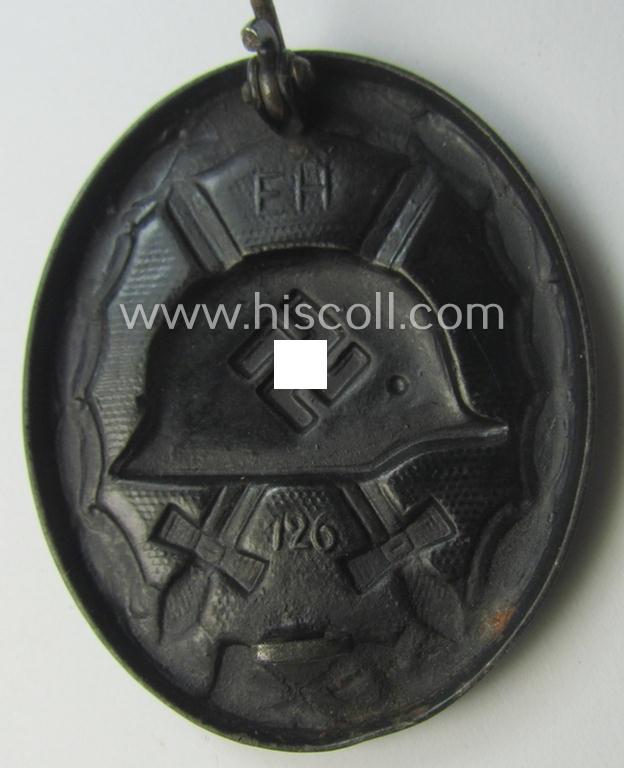 Dual-maker- (ie. 'E.H.'- and/or: '126'-) marked example of a black-class wound-badge (or: 'Verwundeten-Abzeichen in Schwarz') being an example that was produced by the maker (ie. 'Hersteller') named: 'Eduard Hahn'