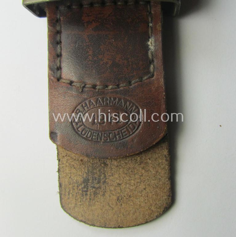 'Virtually mint', 'standard-issue'-pattern, WH (Heeres) field-grey-toned- and/or steel-based belt-buckle being a non-maker-marked example that comes mounted onto its 'B. Haarmann'-marked and/or '1941'-dated tab