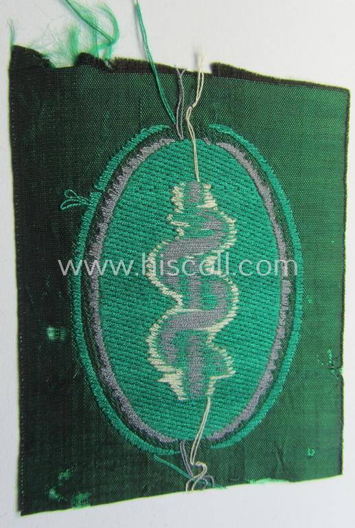 Attractive, 'Sicherheits- u. Hilfsdienst' (ie. 'SHD'-) armbadge (ie. 'Ärmelabzeichen') being a greyish-coloured example depicting an: 'Aesculapus'-symbol as was intended for a: 'Feldscher' (ie. medical SHD-staff-member)