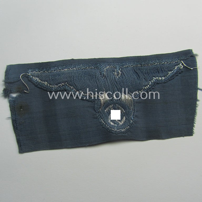 BZP (ie. 'Bahnschutz-Polizei') officers'- (ie. NCO-) pattern side-cap- (ie. 'Schiffchen'-) eagle as woven in 'flat-wire-BeVo'-style and executed in bright-silver thread on a greyish-blue-coloured and/or linnen-based background